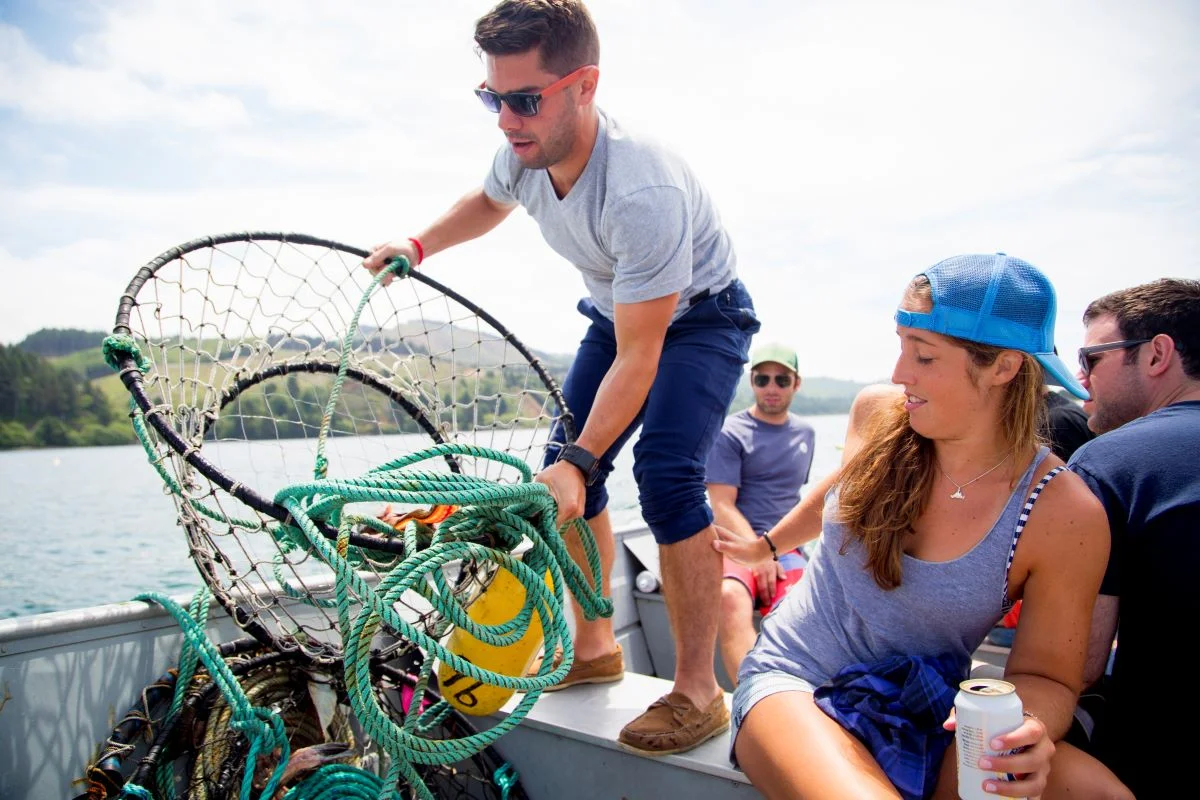 adult-friends-preparing-crab-trap-on-fishing-boat-2024-06-13-20-48-55-utc