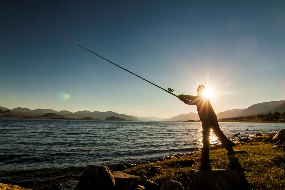 silhouette-of-a-fisherman-at-sunset-fishing-on-mo-2023-11-27-05-06-21-utc